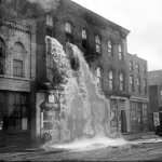 A distillery in Detroit discovered by prohibition agents who destroyed equipment, causing alcohol to pour out of windows