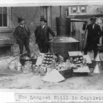 Lieutenant O.T. Davis, Sergeant J.D. McQuade, George Fowler of the IRS and H.G. Bauer posed with the largest bootlegging still confiscated until that date in 1922