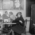 Woman pouring alcohol out of her walking stick, 1922