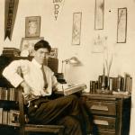 Ohio State student sitting at desk with Ohio Dry banner on wall above desk