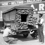 Alerted by the smell of a broken bottle of liquor, Federal Agents inspect a “lumber truck”. Los Angeles, 1926