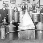 Law enforcement officers posing with stills seized in Vancouver, 1917